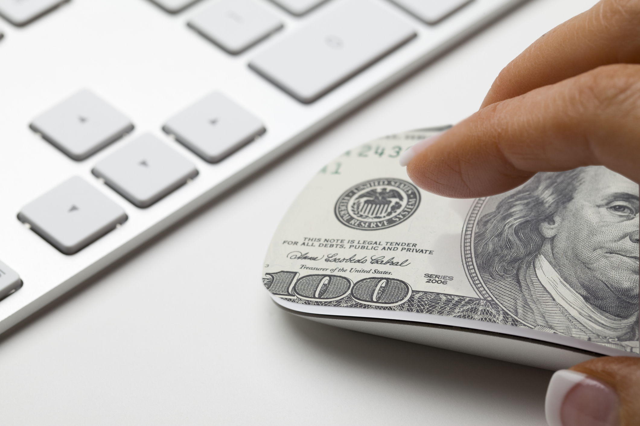 Hand on a computer mouse that looks like a dollar