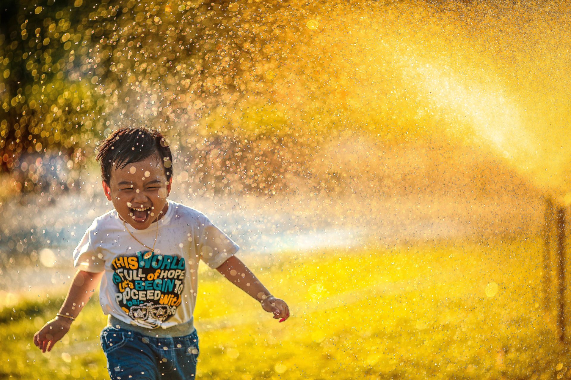 Child running through water happily
